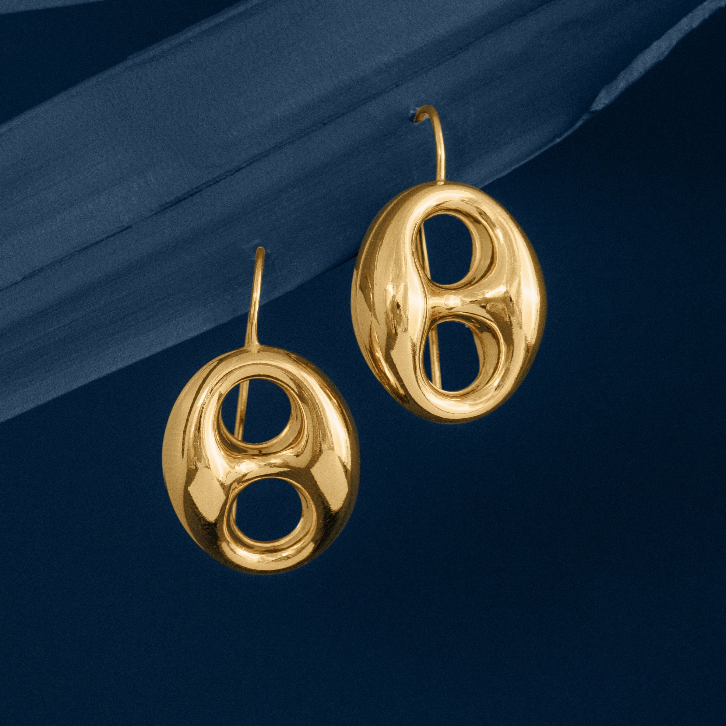 Gold Anchor Mariner Link Drop Earrings on Blue background