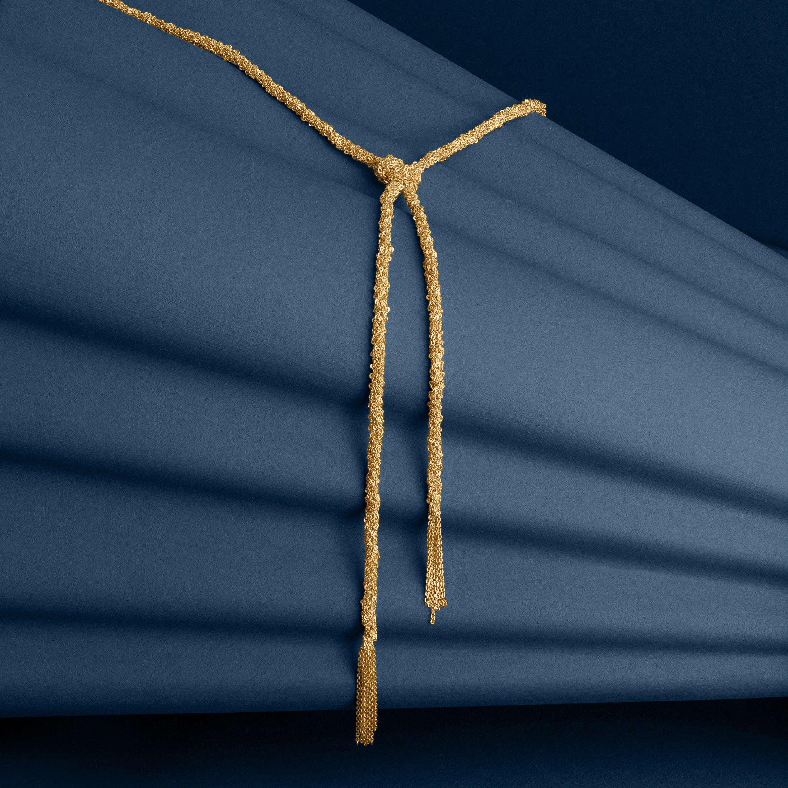 Loel Gold Thread Lariat Necklace Alternative on Blue Background