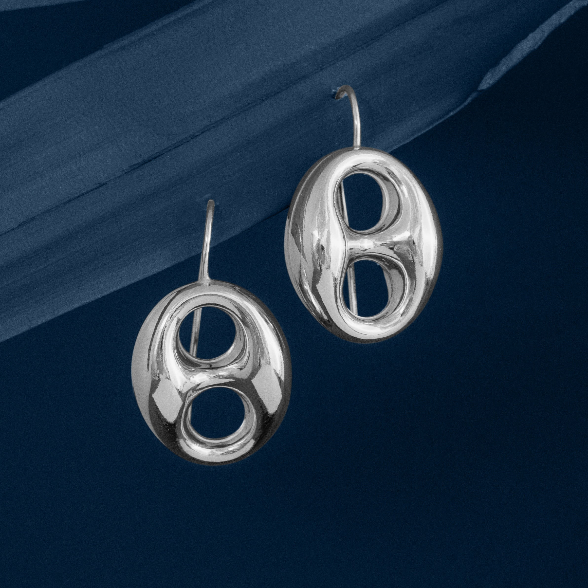 Silver Anchor Mariner Link Drop Earrings on blue background