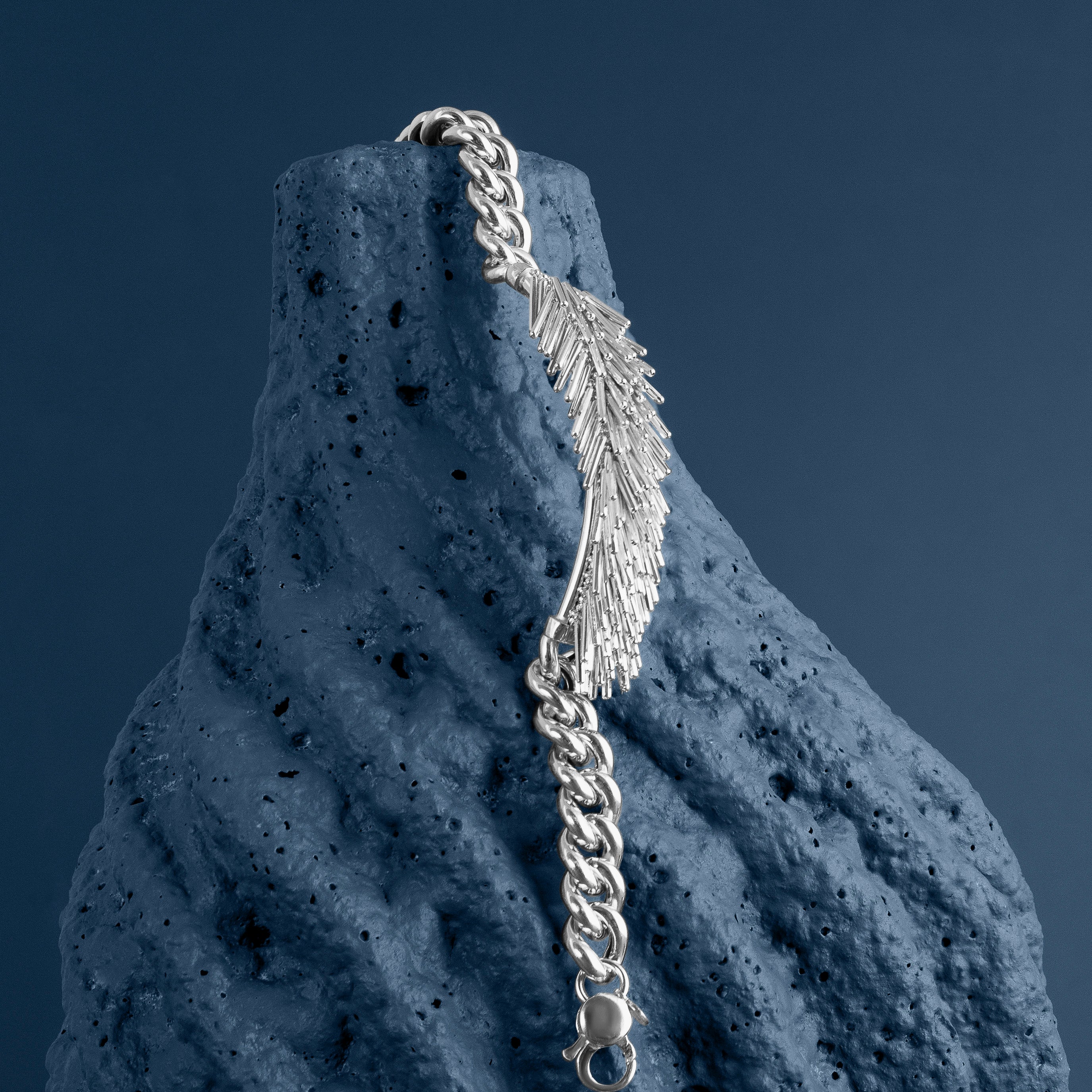 LOEL - Silver Tassel and Chain Bracelet hanging from textured blue stone