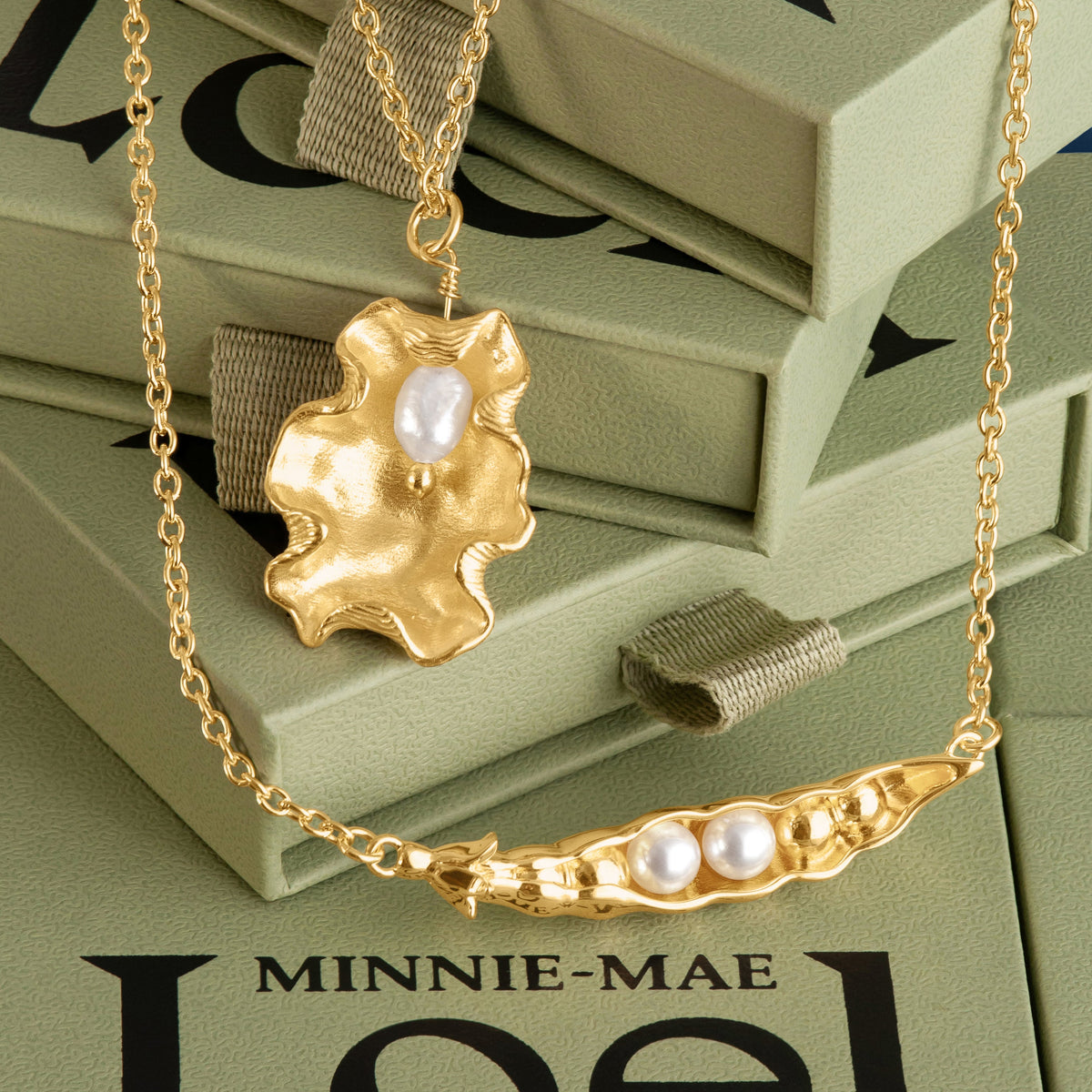 Loel x Minnie Mae Oyster Shell and Peas in a Pod Pendant on Green boxes