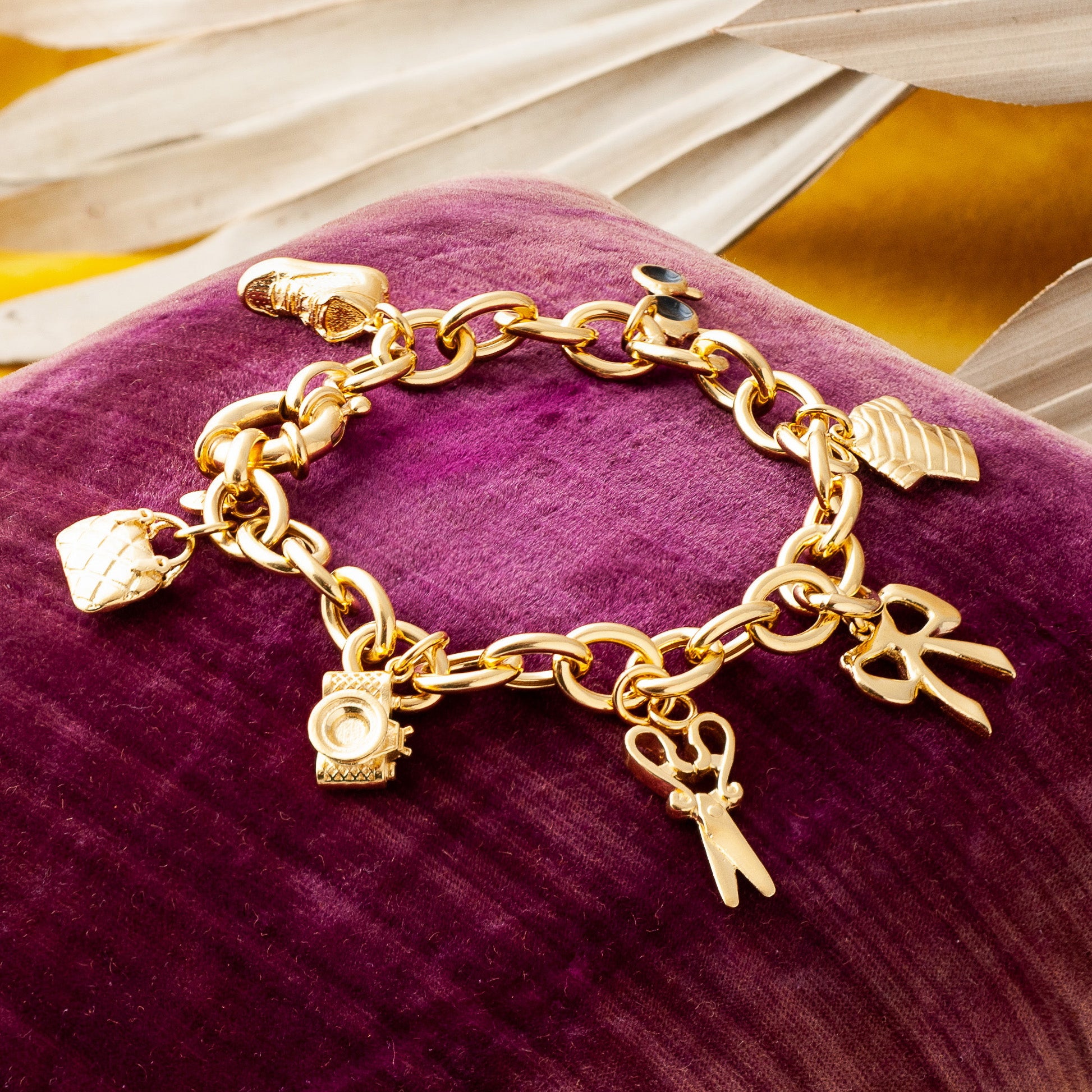 Gold charm bracelet with scissors charm