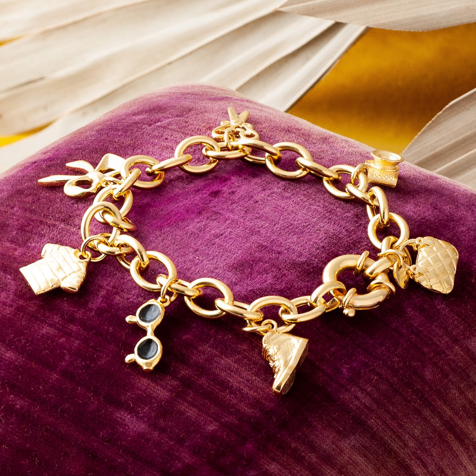 Gold Charm bracelet with trainer charm.