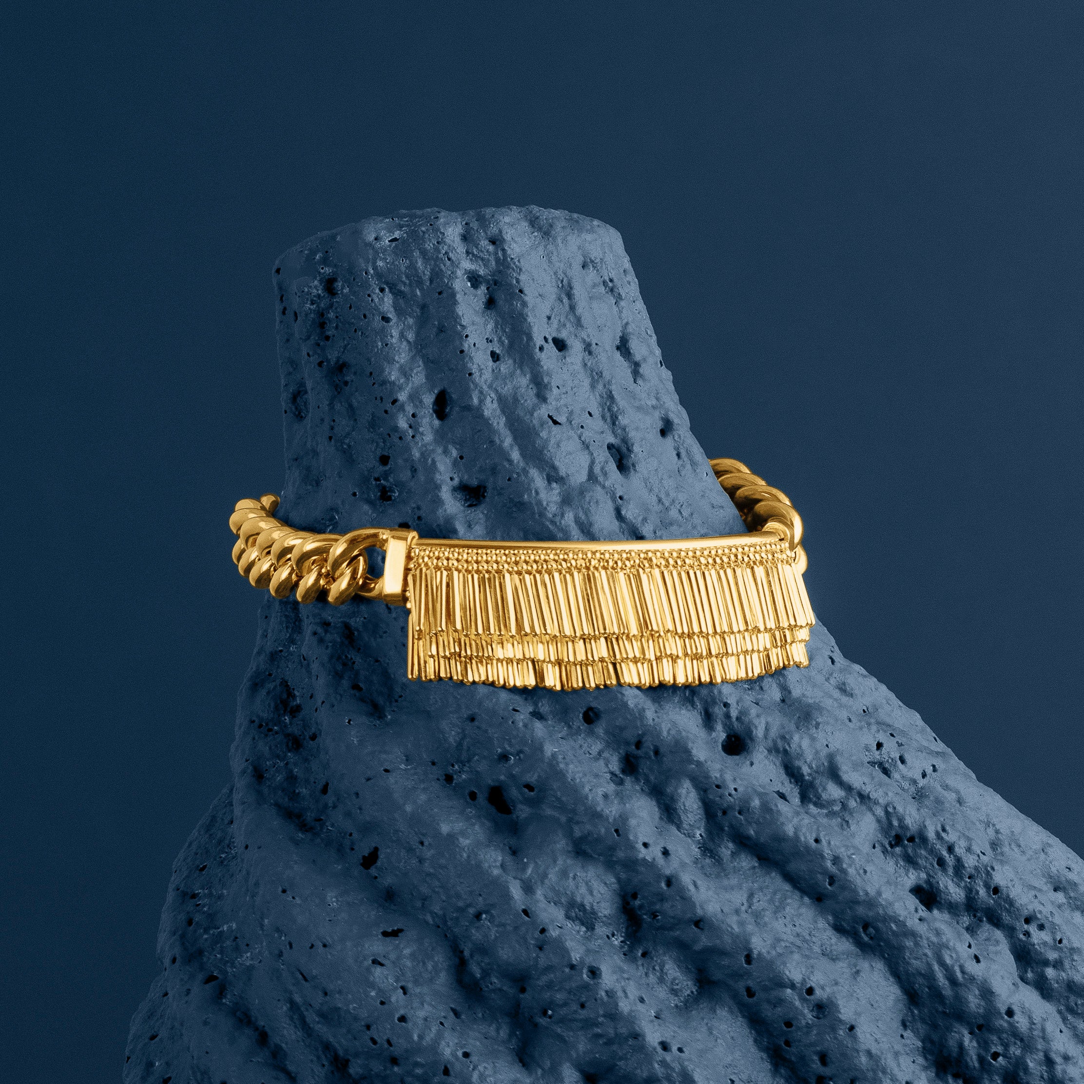 LOEL - Gold Tassel and Chain bracelet on blue textured stone 