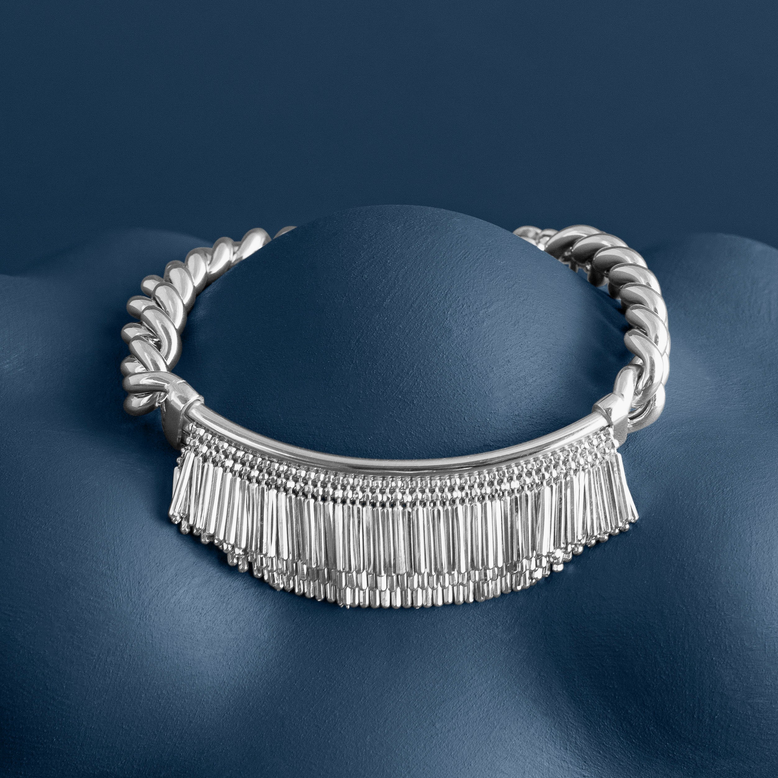 Loel - Silver Tassel and Chain bracelet on smooth blue surface