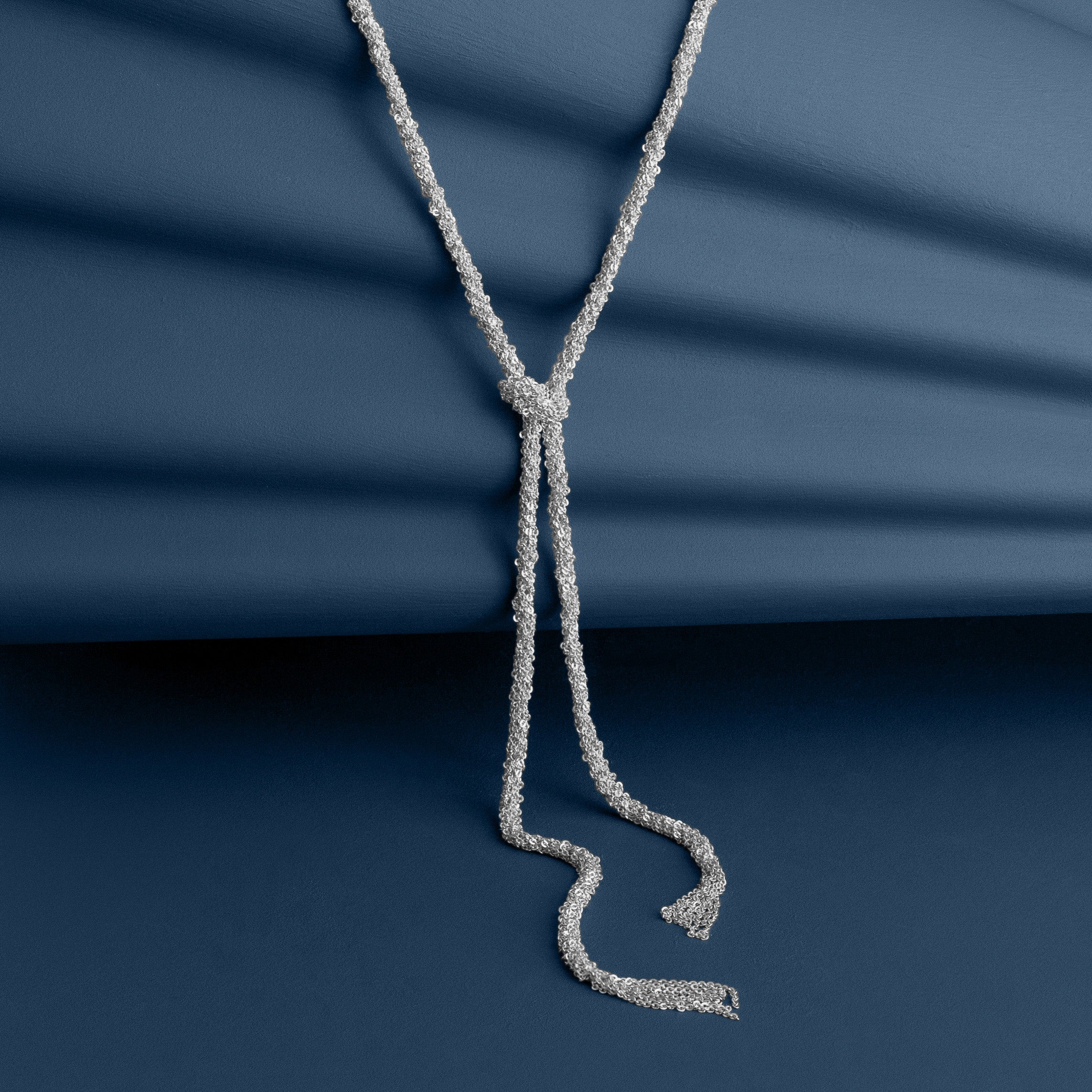Loel Silver Thread Lariat Necklace in blue background