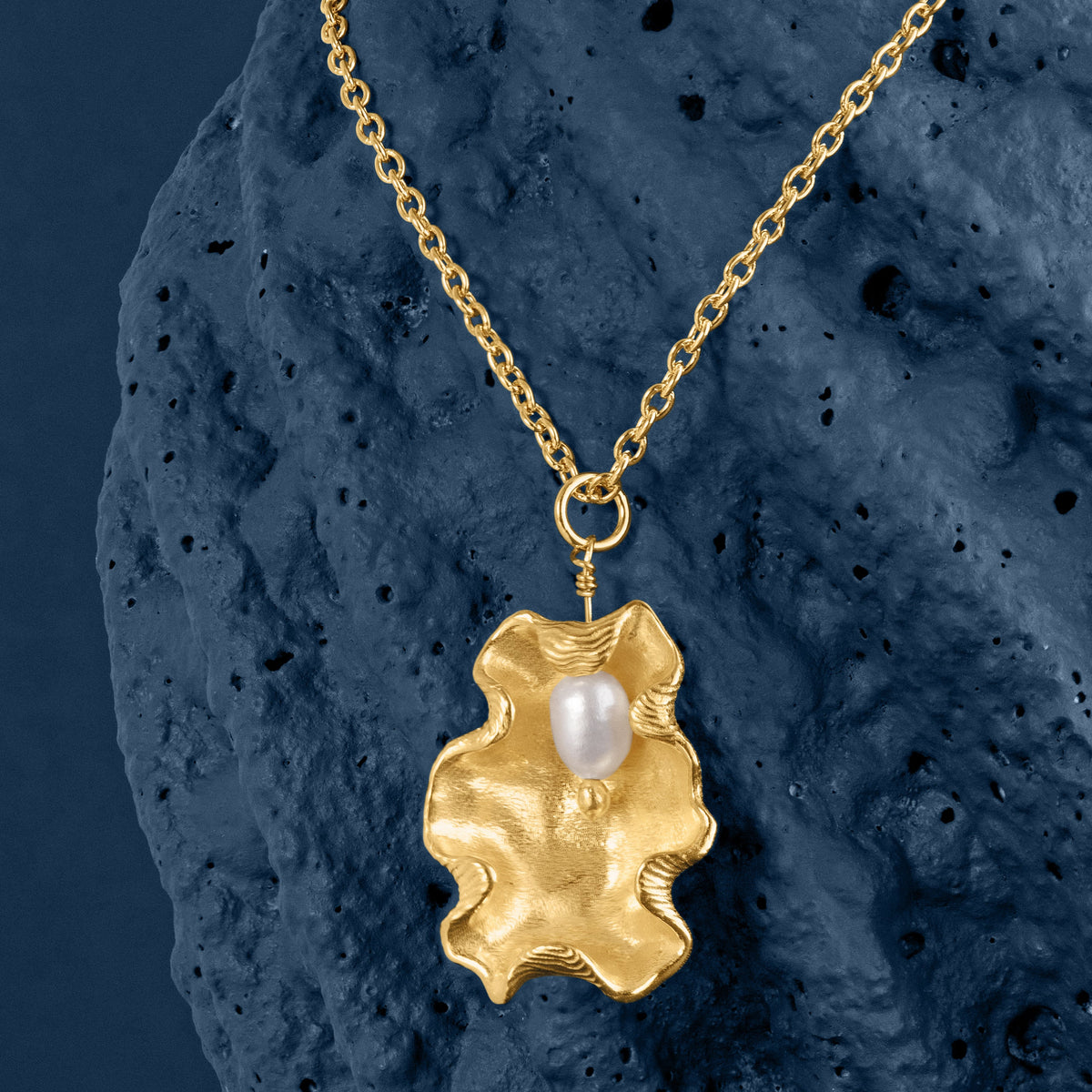 LOEL x Minnie Mae - Gold Oyster Shell and Pearl Pendant on Blue background