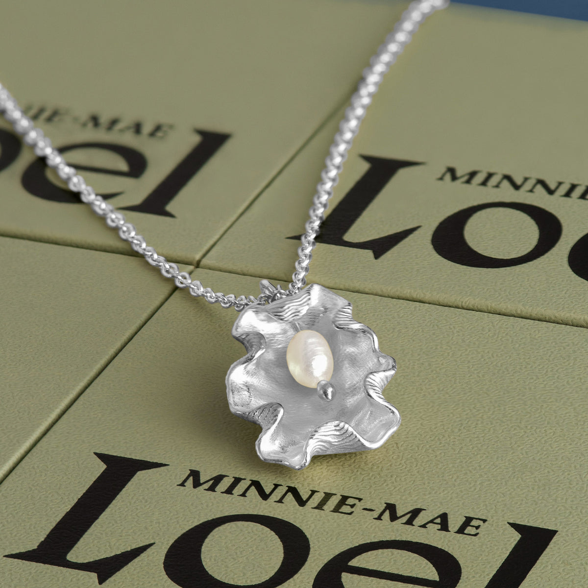 Loel x Minnie Mae Silver Oyster Shell Pendant on boxes v2