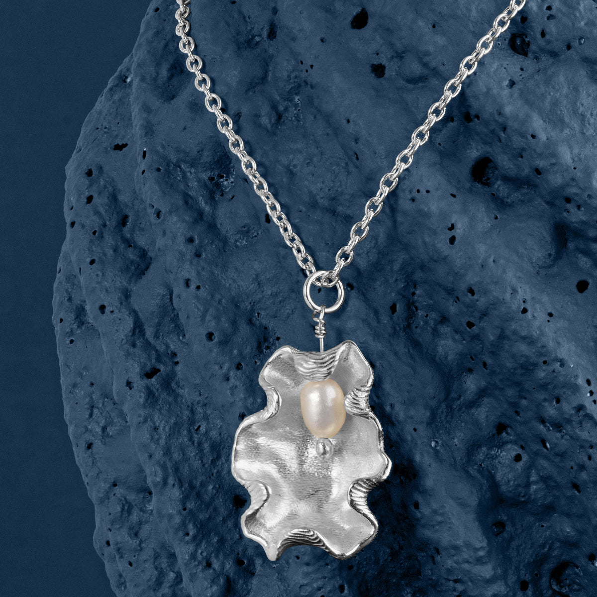 Loel x Minnie Mae Silver Oyster Shell Pendant on blue v3
