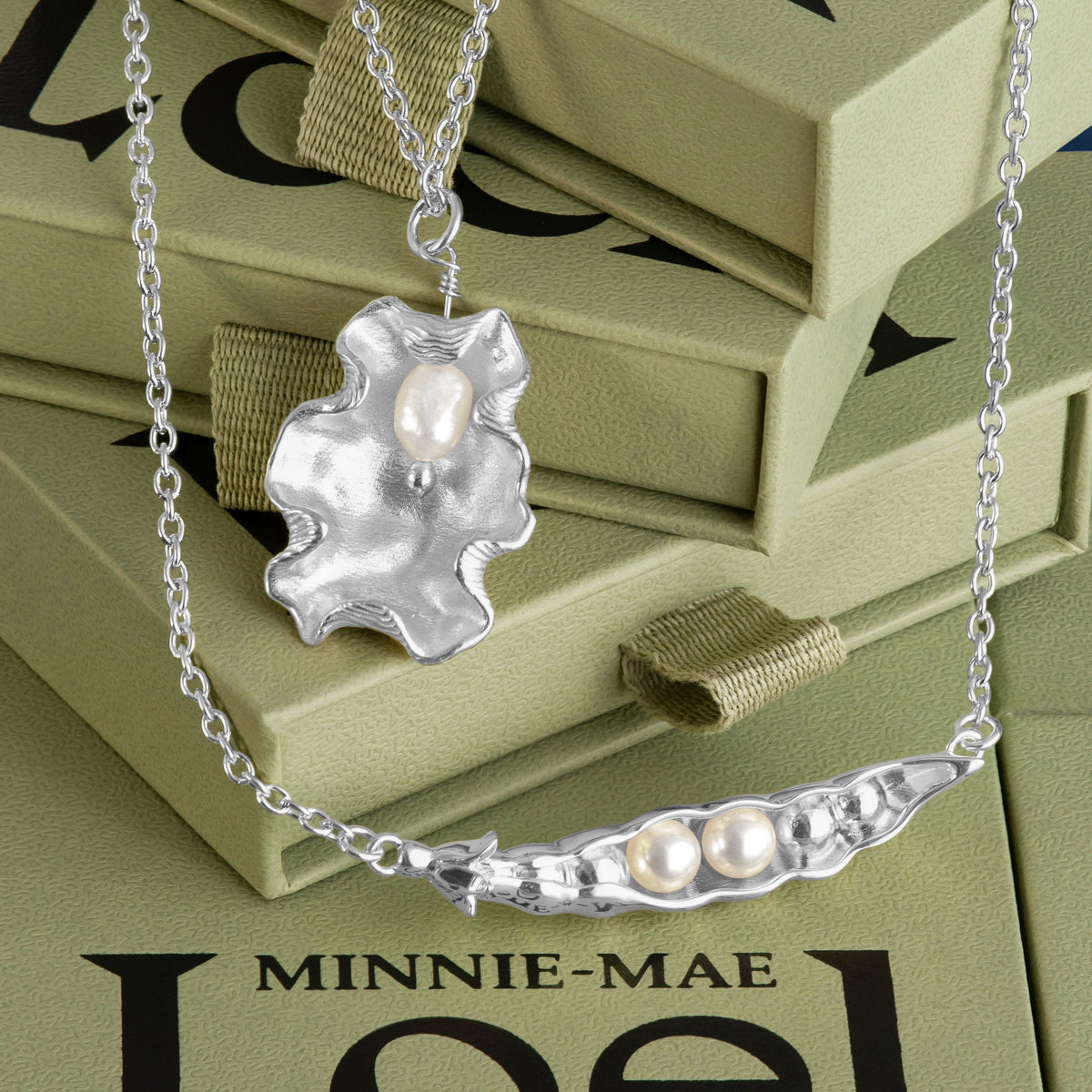 Loel x Minnie Mae Silver Peas in a Pod and Oyster Shell Pendants on boxes